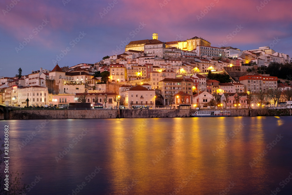 Coimbra city in Portugal. Night panorama with illumination and the Mondega River.