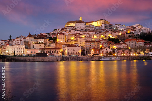 Coimbra city in Portugal. Night panorama with illumination and the Mondega River. photo