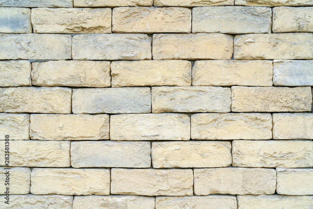 Texture of yellow brick made of sandstone and limestone. The wall of the house. Texture of yellow brick made of sandstone and limestone. The wall of the house.