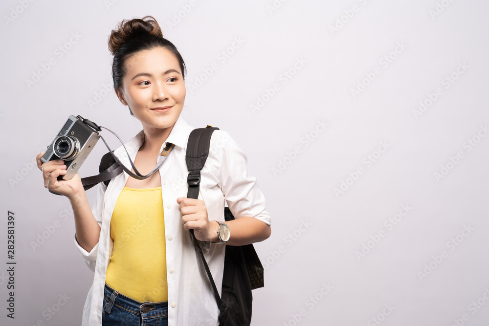 Happy woman holding camera over background Happy woman holding camera over background