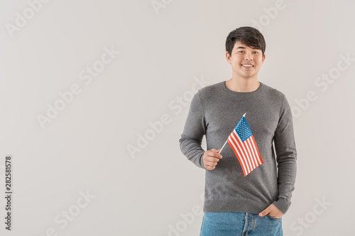 Young Asian man with USA fl...