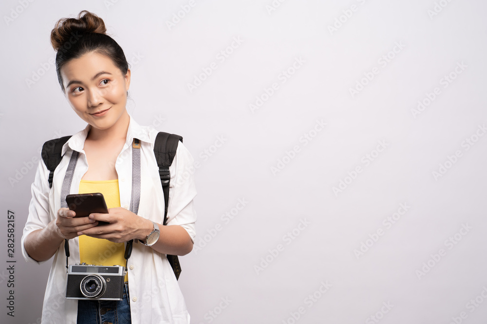 Tourist woman holding smartphone isolated over white background