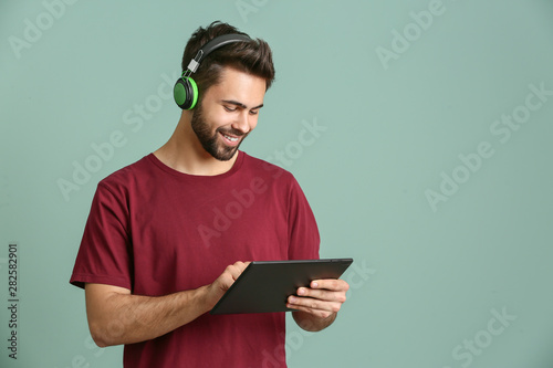 Young man listening to audi...
