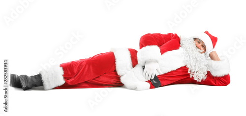 Portrait of lying Santa Claus on white background