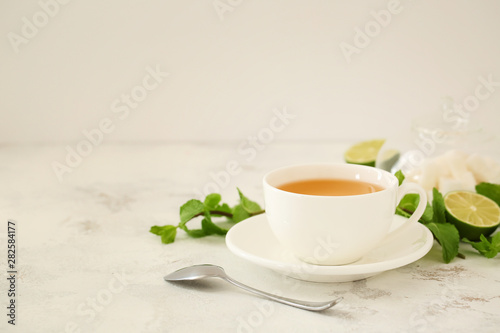 Cup of hot tea on table