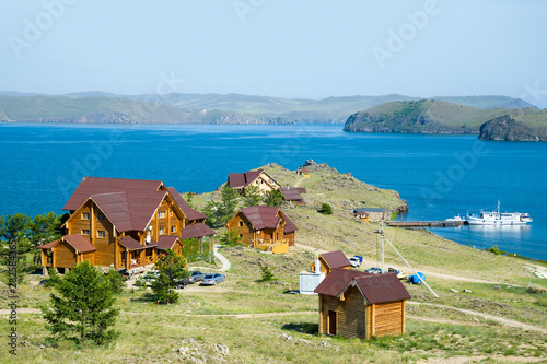 Beautiful view of the tourist center on the shore of Lake Baikal. Far left - Olkhon island. Siberia, Russia. 