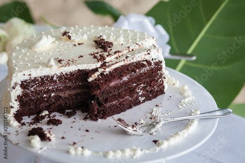 The wedding cake is cut into pieces.