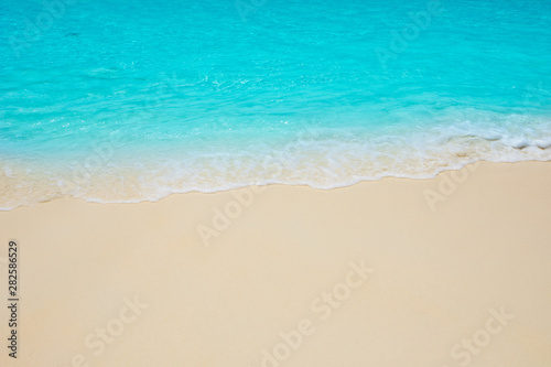 Fototapeta Naklejka Na Ścianę i Meble -  Soft waves of blue sea on the Maldives beach for the background.