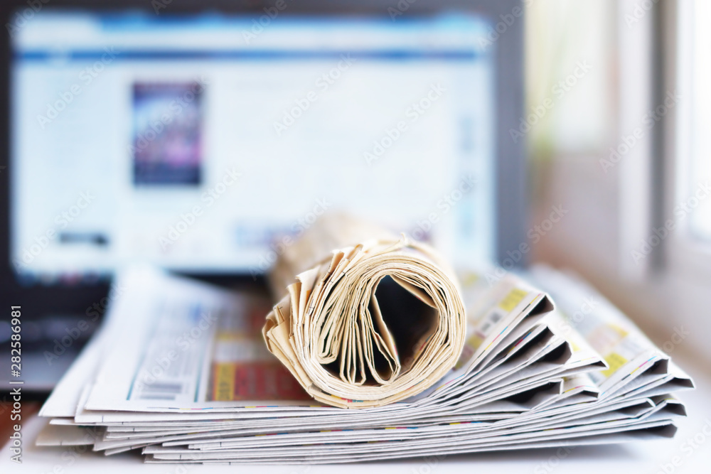 Newspapers and Laptop. Different Concepts for News - Social Network or Traditional Tabloid Journals. Data Sources - Electronic Screen of Computer or Paper Pages of Magazines, Internet or Papers Newspapers and Laptop. Different Concepts for News - Social Network or Traditional Tabloid Journals. Data Sources - Electronic Screen of Computer or Paper Pages of Magazines, Internet or Papers