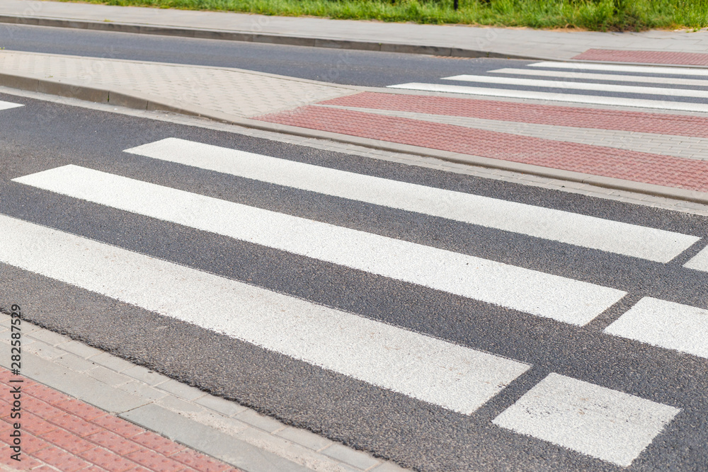 Obraz premium Zebra cross walk on asphalt road. The crosswalk is in the city