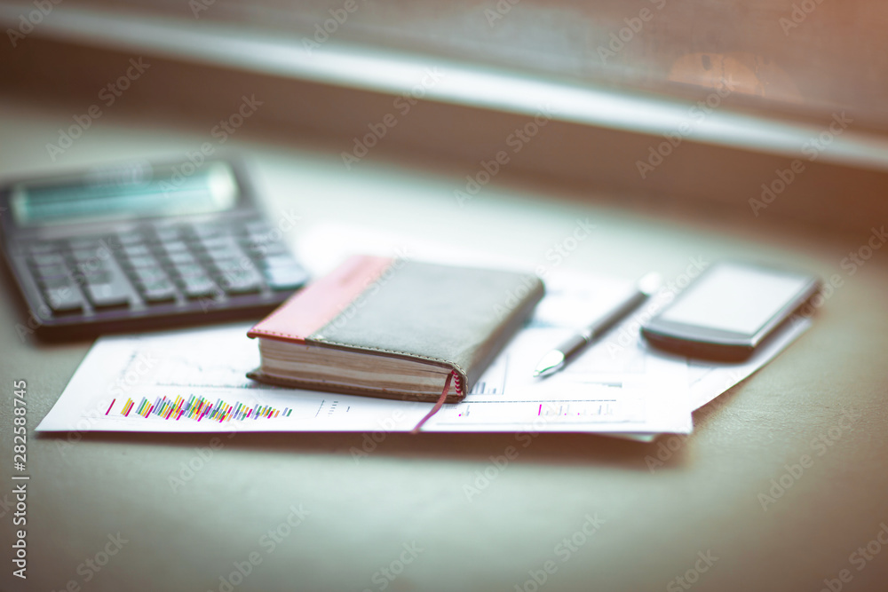 Fototapeta premium Drawings and charts of successful business, workplace of the businessman