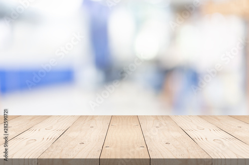 Empty brown wood table top on blur background at shopping mall, copy space for montage you product © sorrapongs