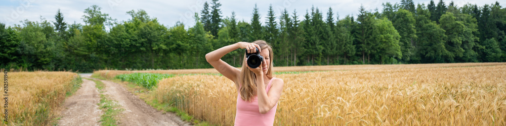 Wide view image of a woman making photos in nature Wide view image of a woman making photos in nature