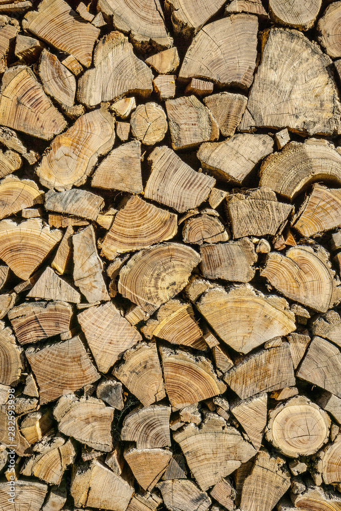 Neatly stacked firewood. Background of dry chopped logs Neatly stacked firewood. Background of dry chopped logs