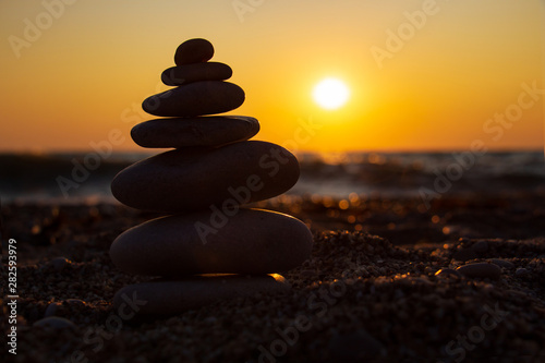 The object of the stones on the beach at sunset