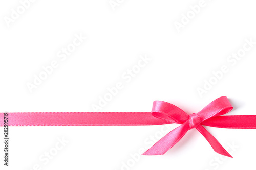Pink ribbon with bow isolated on white background. Gift concept