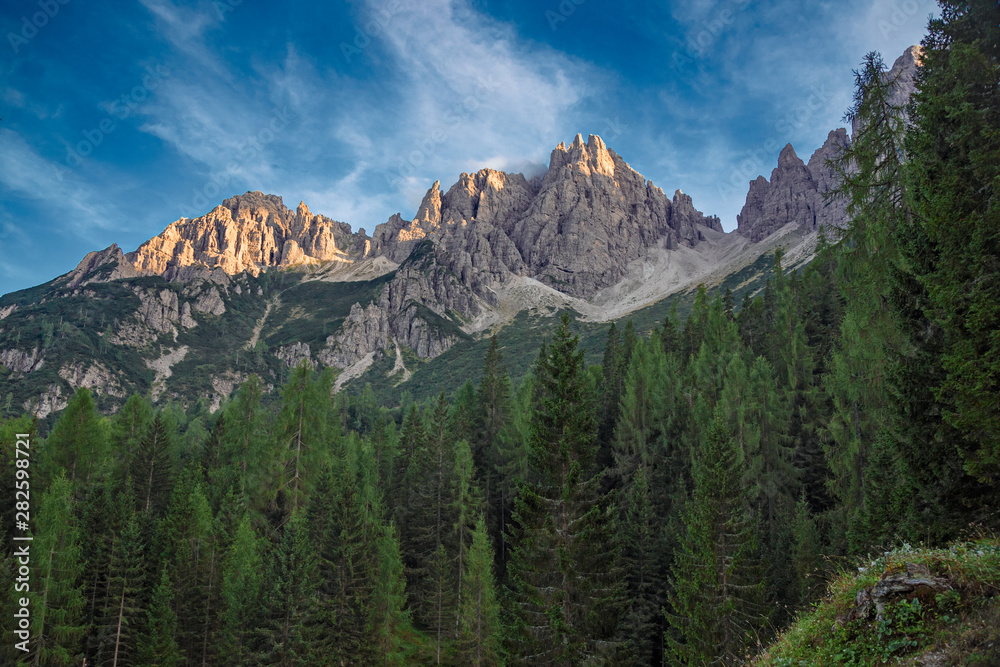 The last rays of the setting sun illuminate the peaks of the Friulian Dolomites, near the Rifugio Giaff, in Friuli, Italy.