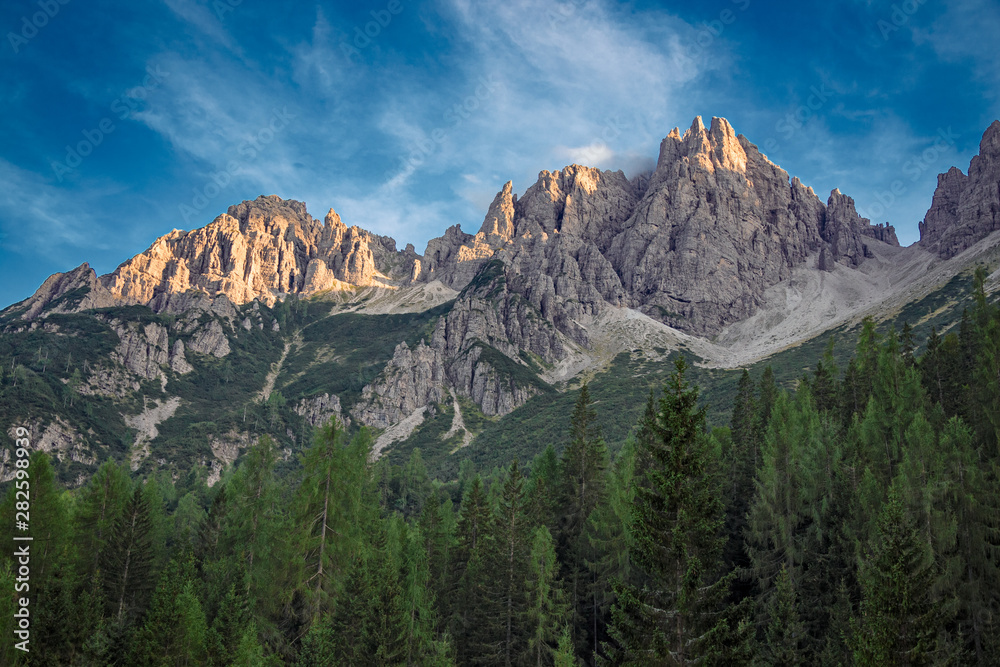 The last rays of the setting sun illuminate the peaks of the Friulian Dolomites, near the Rifugio Giaff, in Friuli, Italy.