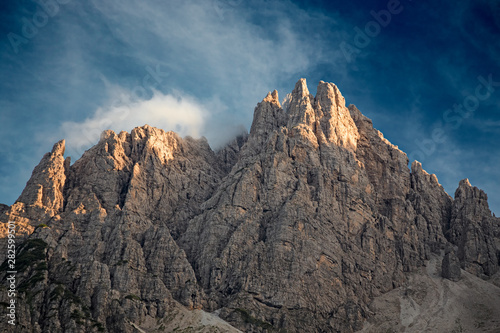 The last rays of the setting sun illuminate the peaks of the Friulian Dolomites  near the Rifugio Giaff  in Friuli  Italy.