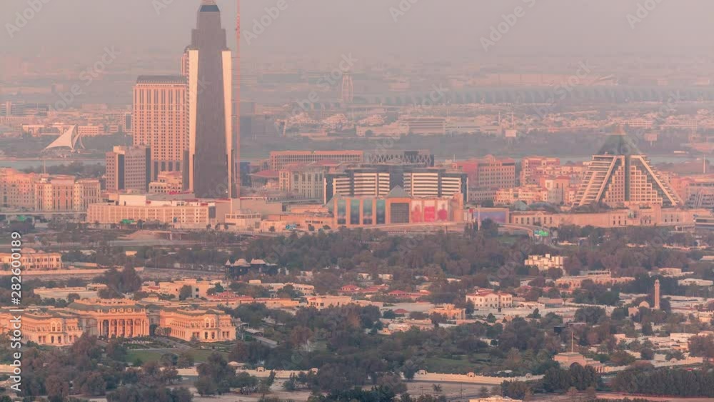 Aerial view of neighbourhood Deira and Dubai creek with typical old and modern buildings timelapse. Airport on a background. View from skyscraper rooftop before sunset. Dubai, United Arab Emirates Aerial view of neighbourhood Deira and Dubai creek with typical old and modern buildings timelapse. Airport on a background. View from skyscraper rooftop before sunset. Dubai, United Arab Emirates