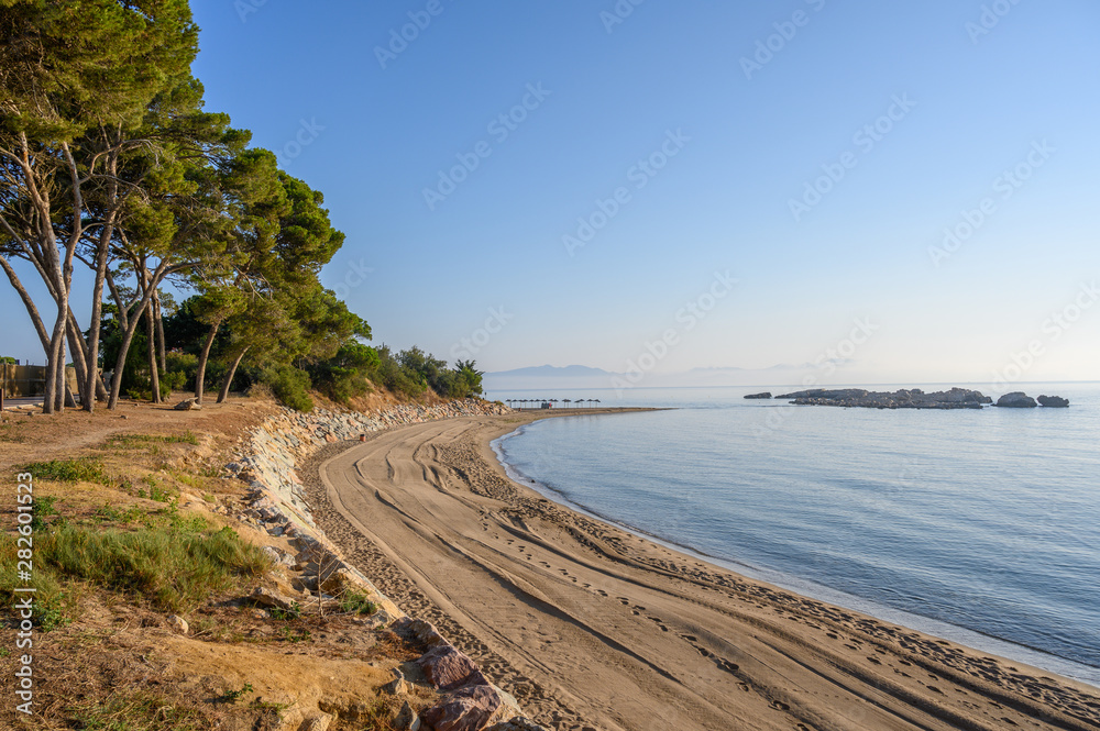 Empty Beach with natural sun shades and rocks at L'Escala, Catalonia, Costa Brava Spain Empty Beach with natural sun shades and rocks at L'Escala, Catalonia, Costa Brava Spain