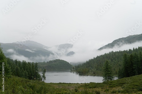 low clouds and fog over the river in the mountains © Ksenia