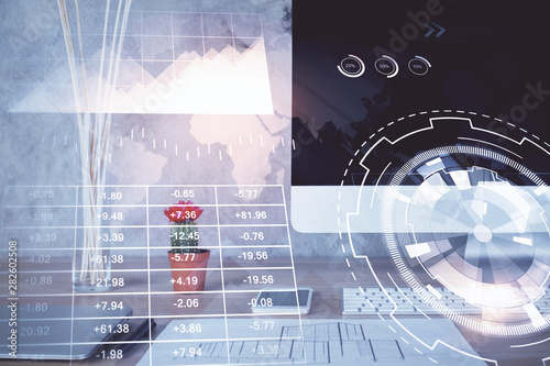 Forex Chart hologram on table with computer background. Multi exposure. Concept of financial markets.