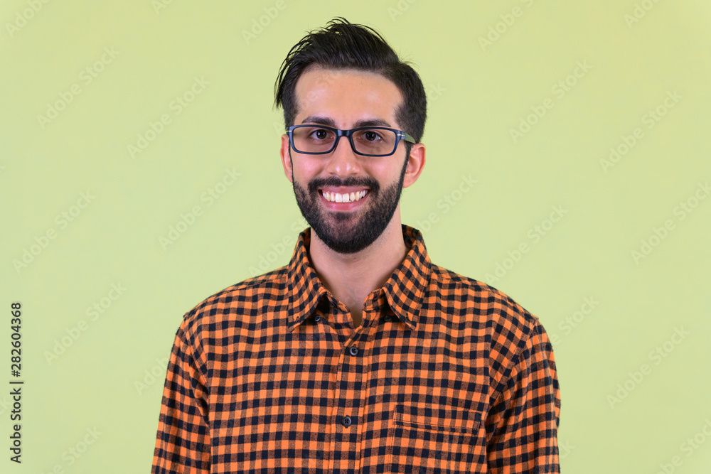 Face of happy young bearded Persian hipster man smiling Face of happy young bearded Persian hipster man smiling