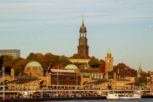 View from the Elbe river towards the St. Pauli Piers or Landungsbrücken and the St. Michael's Church in Hamburg, Germany. photo