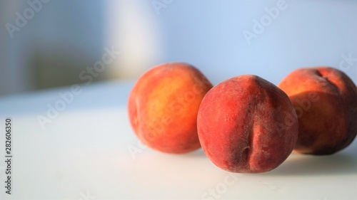 peaches on white glass matte table