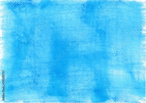 With watercolor pencils hand painted watercolor background in light blue on rough paper
