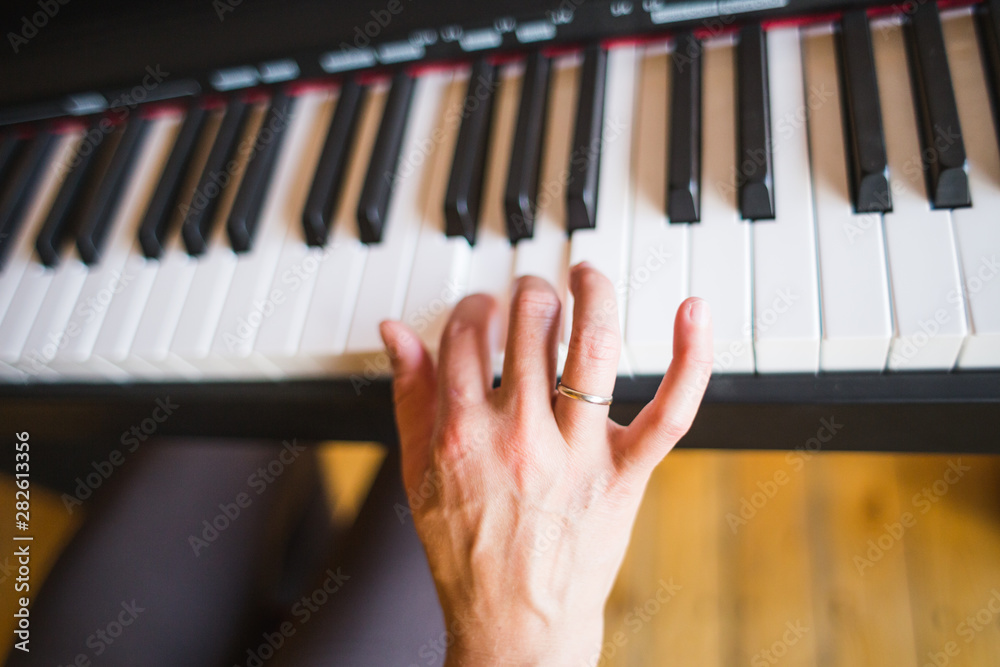 A woman learns to play the piano.