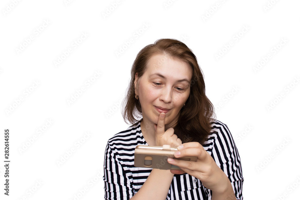 Aged woman holds a smartphone and communicates emotionally in social networks. White background, isolate. Aged woman holds a smartphone and communicates emotionally in social networks. White background, isolate.