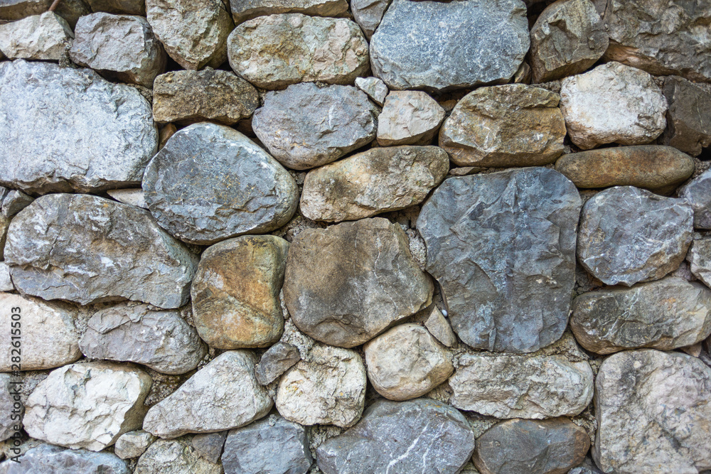 Fototapeta premium Closeup texture of stone wall. Horizontal color photography.