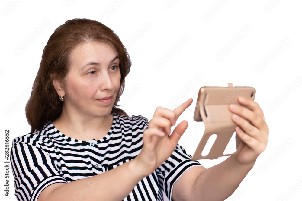 Aged woman holds a smartphone and communicates emotionally in social networks. White background, isolate. Aged woman holds a smartphone and communicates emotionally in social networks. White background, isolate.