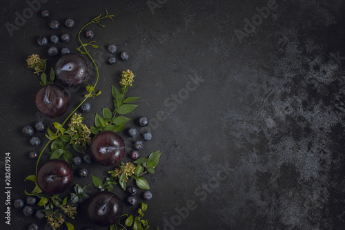 Blueberries and plums copy space