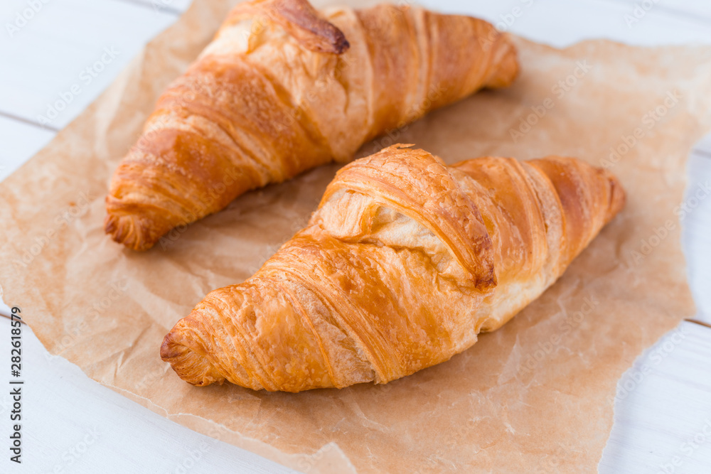 Croissants on a white wooden board. View from above. Top view.