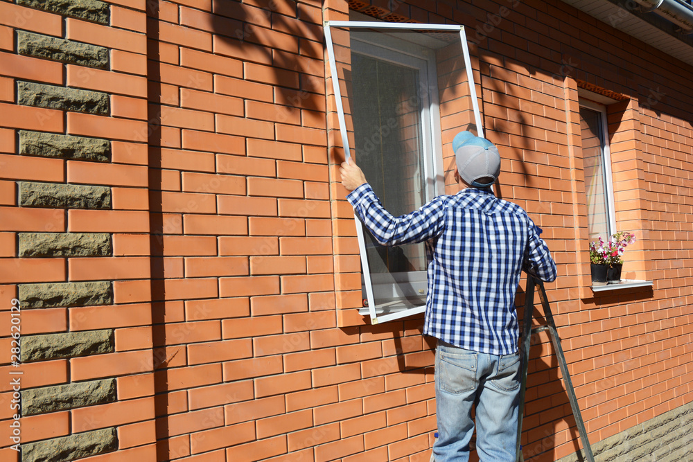 custom made wallpaper toronto digitalMan installing mosquito net screen on house window