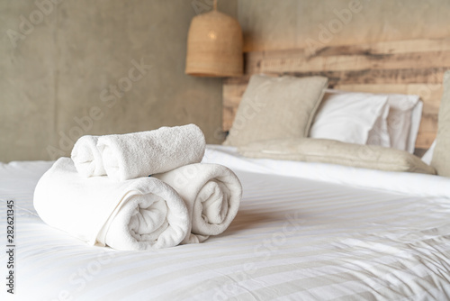 Fototapeta Naklejka Na Ścianę i Meble -  White towel on bed decoration in bedroom