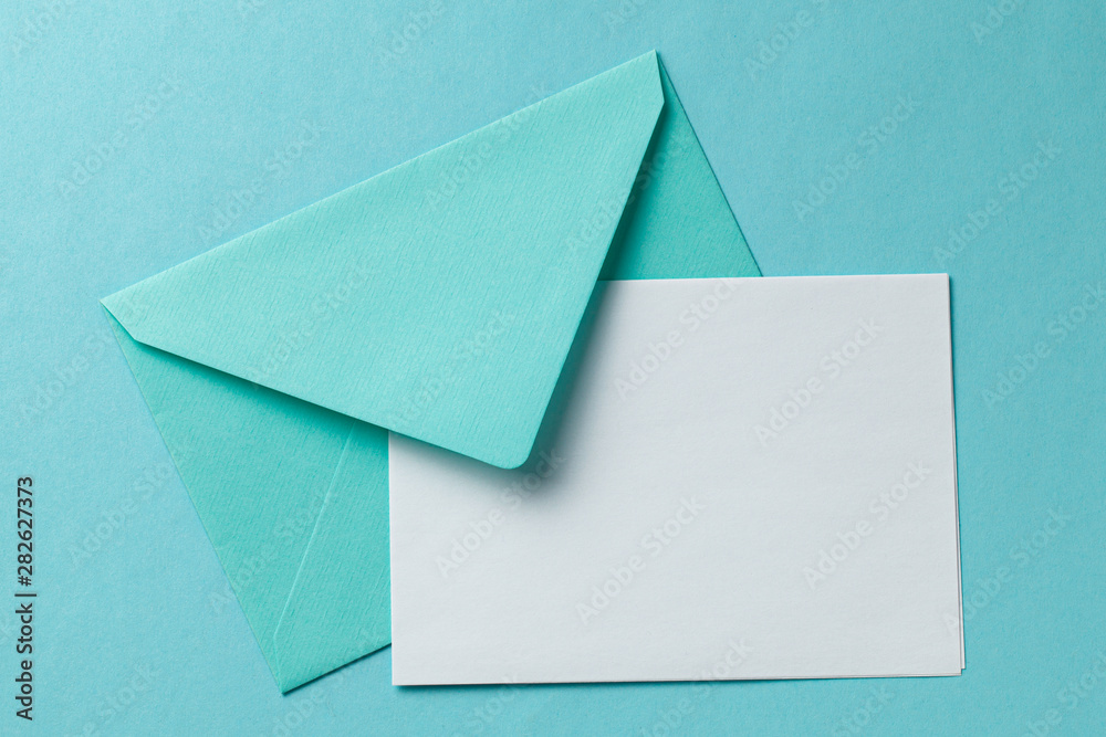 Green envelope and blank letter on green background. Template with place for text on postcard. mock-up Green envelope and blank letter on green background. Template with place for text on postcard. mock-up