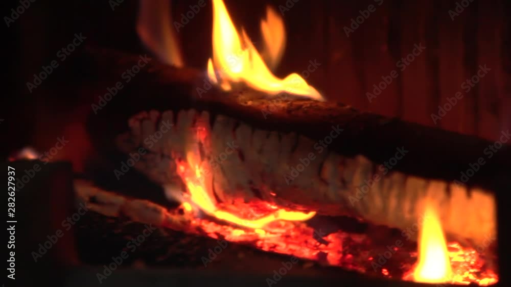 firewood is burning in the fireplace firewood is burning in the fireplace
