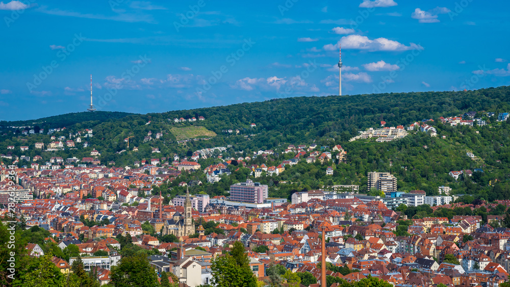 Germany, Cityscape of stuttgart city skyline from above in valley and television tower on forested mountain