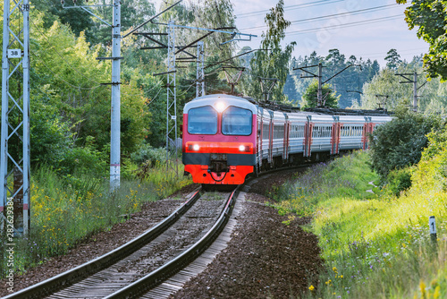 Passenger train moves through countryside, Moscow region. Russia.
