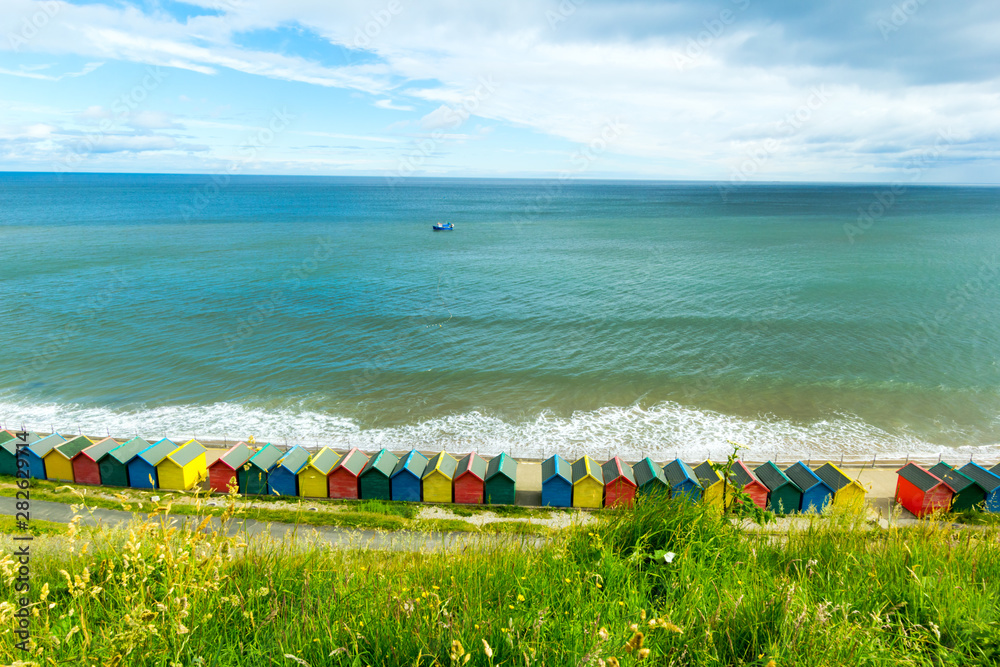 Beautiful view on the sea and beach huts in Whitby, Emgland Beautiful view on the sea and beach huts in Whitby, Emgland