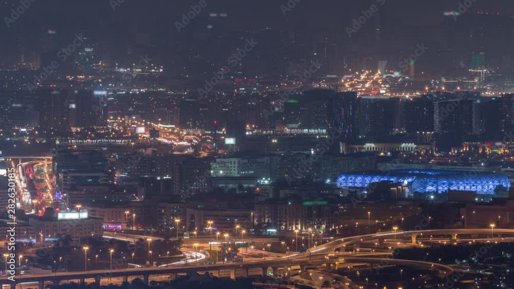 Aerial view of neighbourhood Deira and Dubai creek with typical old and modern buildings night timelapse. Traffic on intersection. View from skyscraper rooftop before sunset. Dubai, United Arab Aerial view of neighbourhood Deira and Dubai creek with typical old and modern buildings night timelapse. Traffic on intersection. View from skyscraper rooftop before sunset. Dubai, United Arab