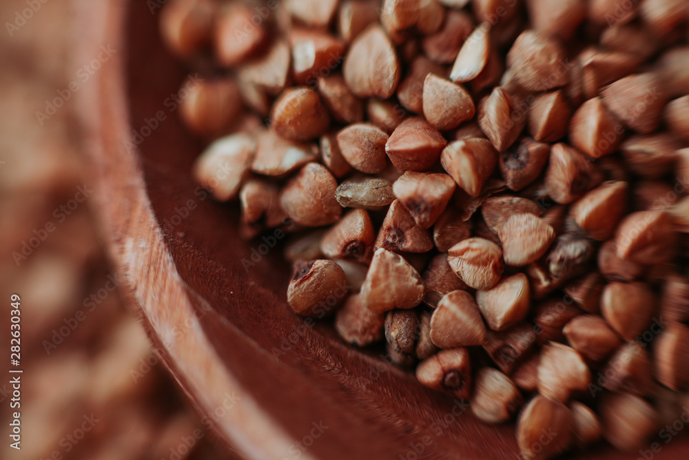 Macro close-up photo of buckwheat groats. Texture background grain buckwheat groats. Image food product porridge buckwheat Macro close-up photo of buckwheat groats. Texture background grain buckwheat groats. Image food product porridge buckwheat