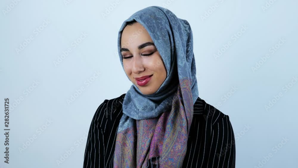 young beautiful arabic woman smiling feeling a bit shy on isolated white background young beautiful arabic woman smiling feeling a bit shy on isolated white background