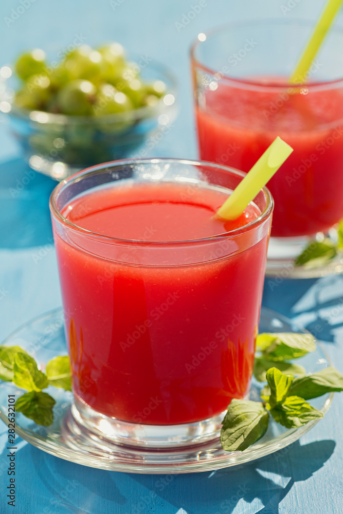 Cold fresh watermelon juice on a wooden blue table. Cold fresh watermelon juice on a wooden blue table.