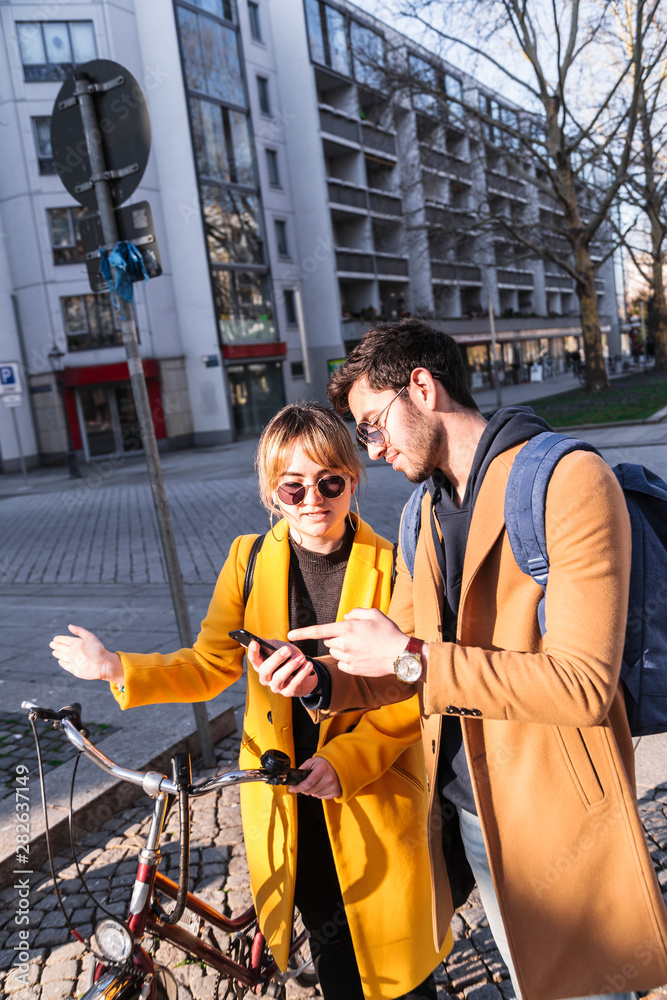 Man and woman looking some information at phone