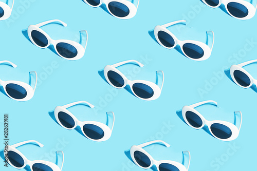 White sunglasses pattern on pastel blue background.